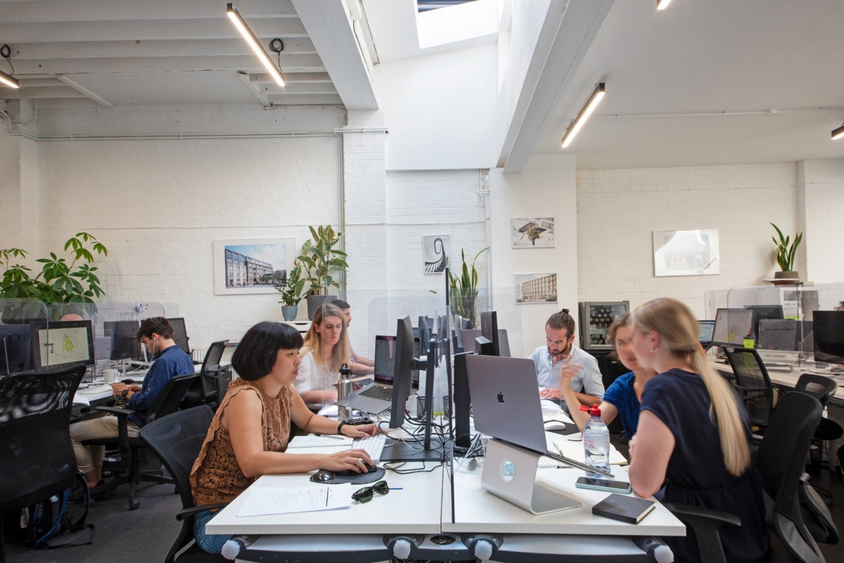 Bright studio desks with monitors under skylights